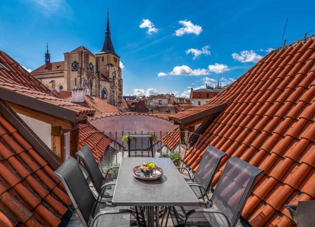Terrace view over the rooftops and church towers of Prague Old Town